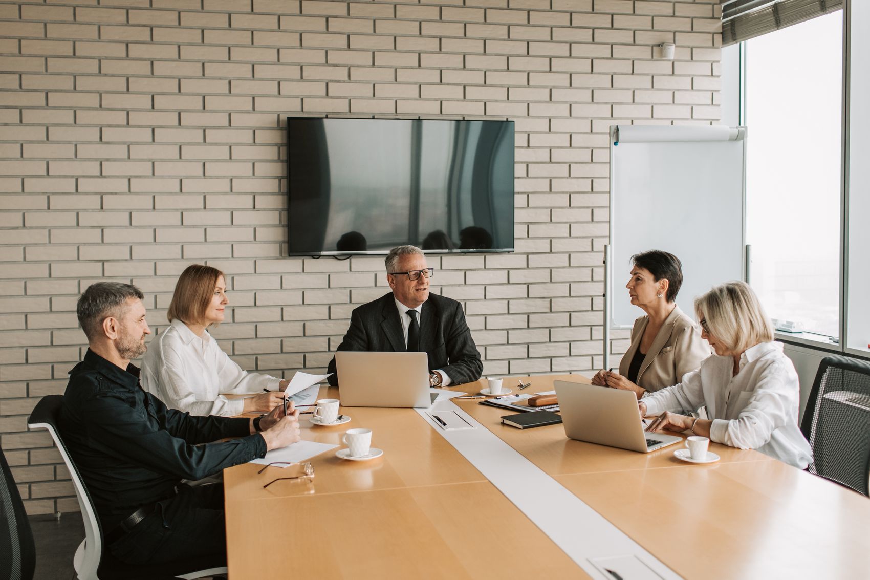 Experienced finance operators in a boardroom meeting